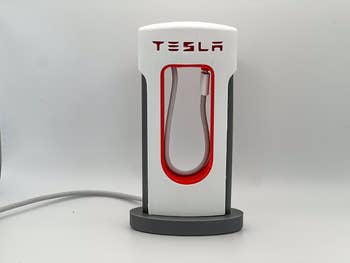 Tesla mobile telephone  charger shaped similar  a Tesla Supercharger, featuring a sleek, modern   design. Perfect for tech enthusiasts