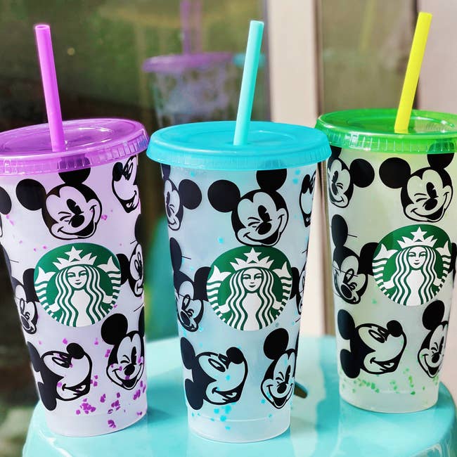 three mickey cups with different colors on them