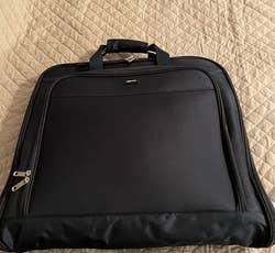 same reviewer's photo of the garment bag packed up into a compact carrying case
