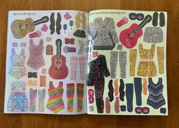Open publication  with sparkly manner  stickers, including guitars, clothes, and accessories