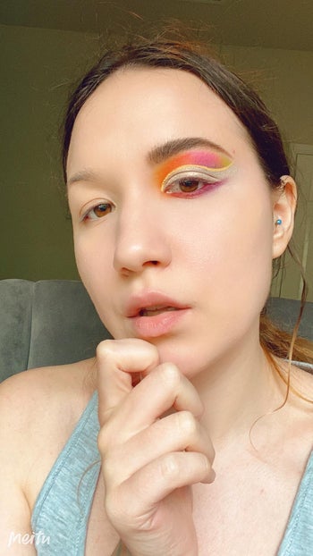 reviewer's eyeshadow look with orange, pink, and yellow shades from the palette