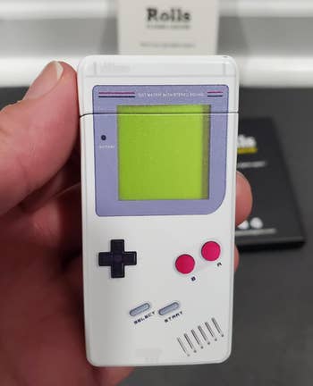reviewer holding a classic Game Boy-inspired lighter 