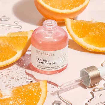 The rose oil surrounded by oranges