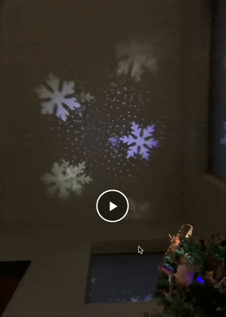 gif of snowflakes projected from star onto ceiling
