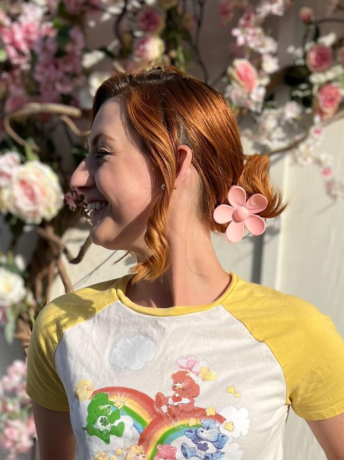 Profile of a person with flower shaped clip in their hair