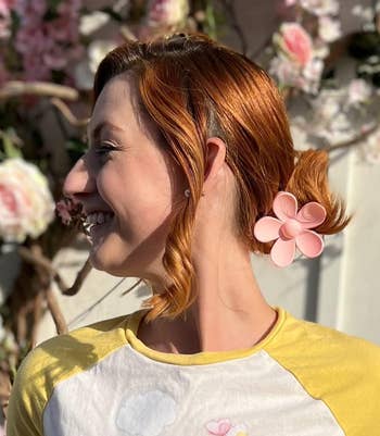 Profile of a person with flower shaped clip in their hair