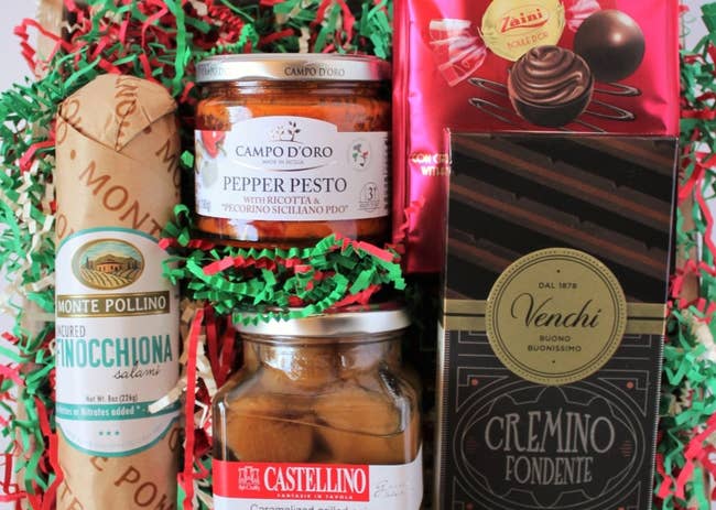 assortment of gourmet italian goodies like caramelized grilled onions, pepper pesto, chocolate truffles, salami, and more 