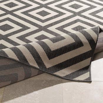 Patterned area rug with geometric design displayed on the floor