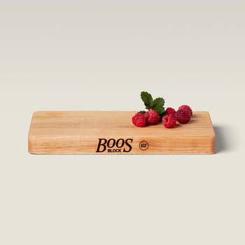 Wooden Boos Block cutting committee  with raspberries and mint connected  top