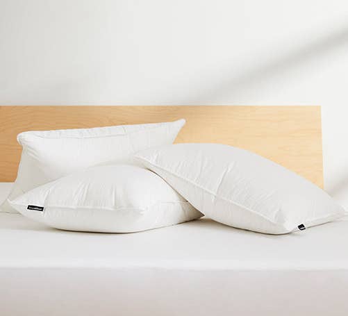 Three pillows stacked on a bed