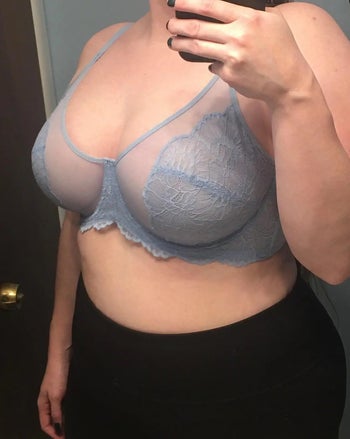 reviewer photo of them wearing a light blue sheer illusion mesh and lace bra