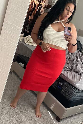 reviewer wearing red skirt