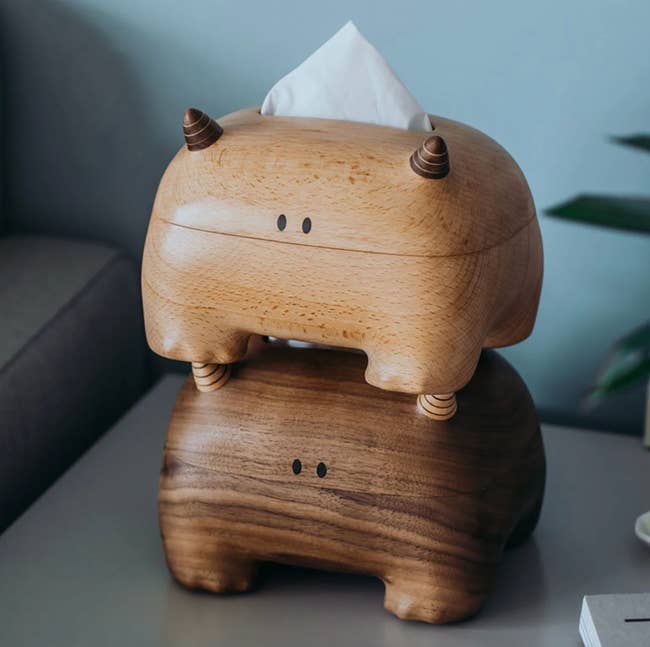 Two monster shaped tissue boxes stacked on top of each other in different finishes