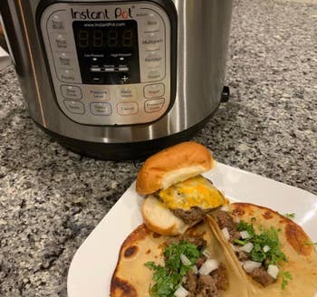reviewer photo of instant pot next to a plate of food