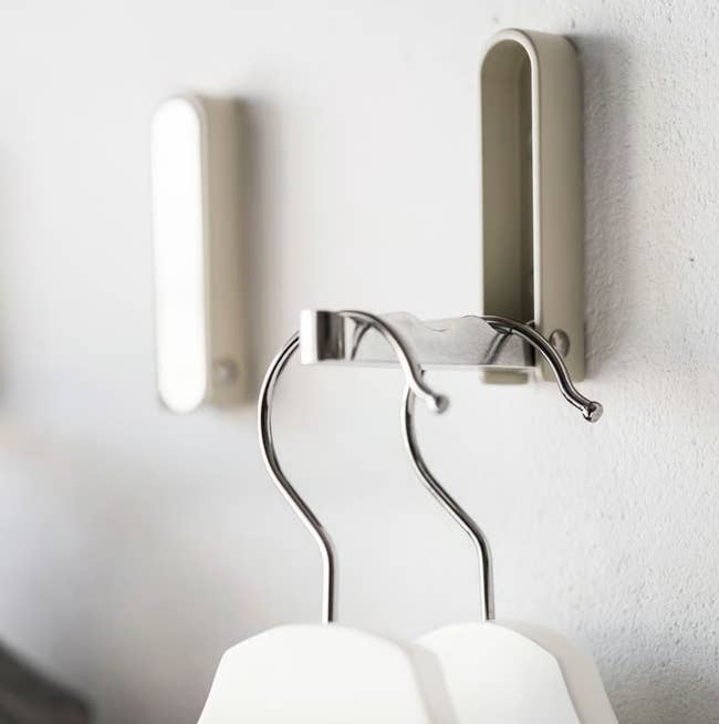 Wall-mounted hooks holding hangers, perfect  for organizing apparel  successful  a compact space