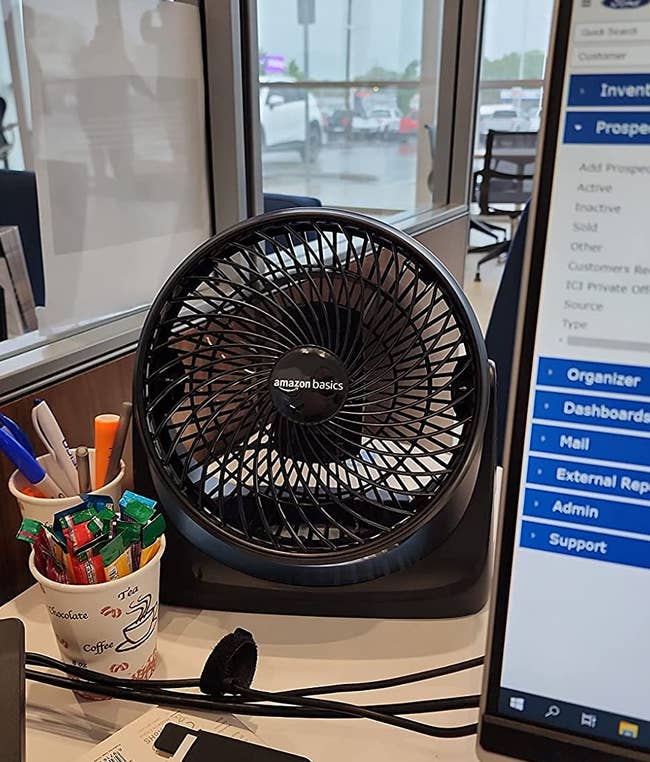 the black fan on a work desk