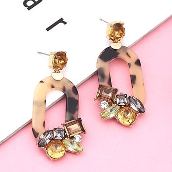 tortoiseshell oval shaped earrings with yellow gray and brown jewels