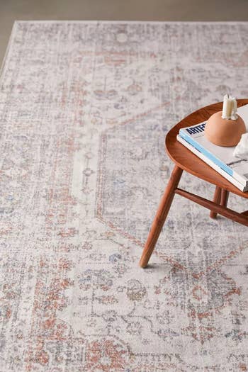 a close-up of the lightly colored rug with a table on top of it