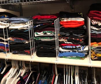 The closet dividers separating piles of folded clothes