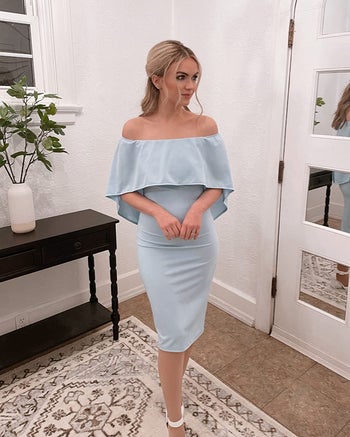 A reviewer wearing the dress in light blue