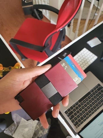 reviewer photo holding slim card holder with several cards fanned out