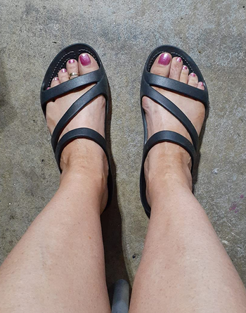 reviewer's feet in the black sandals