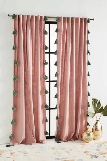 pink curtains with blue tassel trim