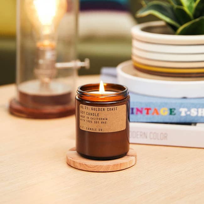 a golden coast candle from p.f. candle co in an amber jar