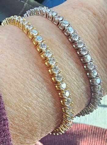 Two tennis bracelets, 1  successful  golden  and 1  successful  silver, some  adorned with sparkling gemstones, showcased connected  a person's wrist