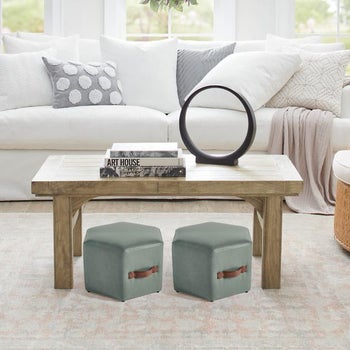 two turquoise hexagonal ottomans under a table