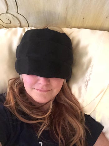reviewer wearing the headache hat in black