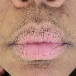 a close-up of a reviewer's upper lip with visible hair 
