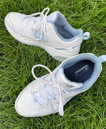 Reviewer's white and blue sneakers on a patch of grass