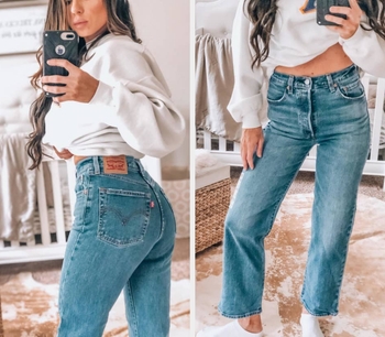reviewer wearing the jeans in medium blue wash