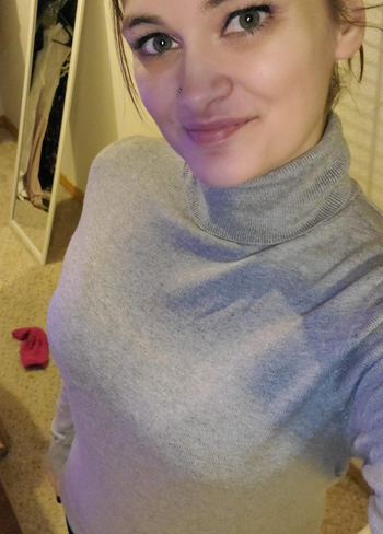 close up of reviewer wearing the gray turtleneck