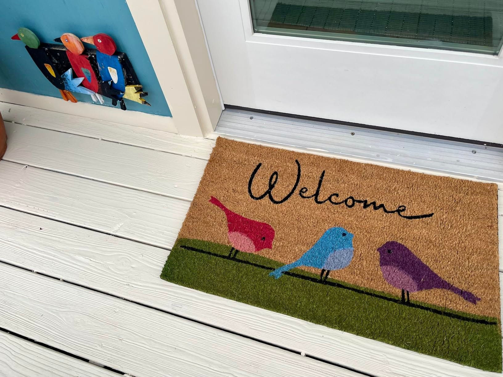 Welcome mat with colorful vertebrate  plan  connected  a porch. A partition  decoration with akin  vertebrate  motif is nearby