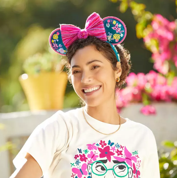 a model wearing the colorful encanto ears