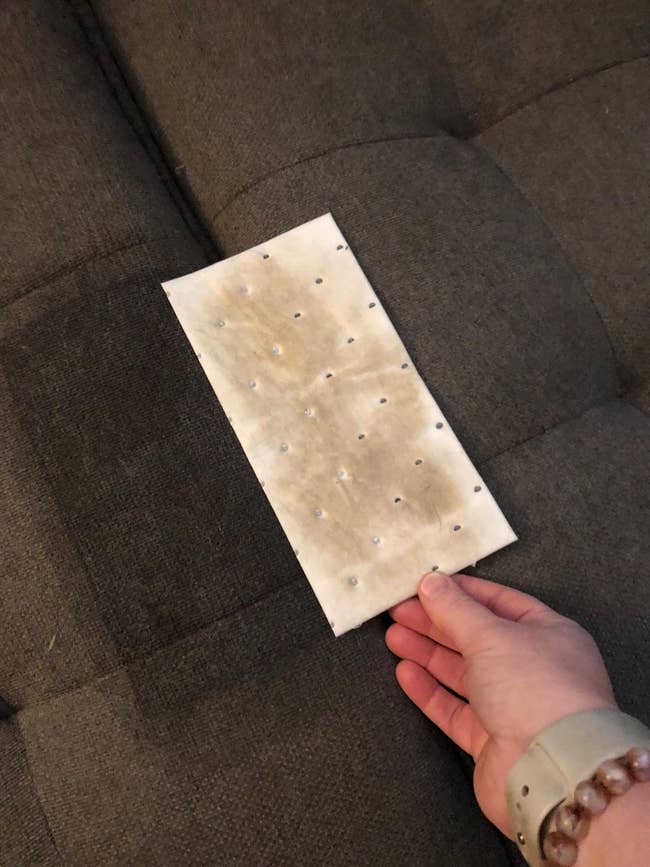 image of reviewer holding soiled stain removal pad