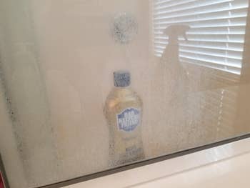 Before photo of a cloudy shower door