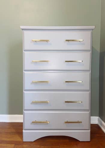 reviewer's white dresser with the gold drawer pulls on it 