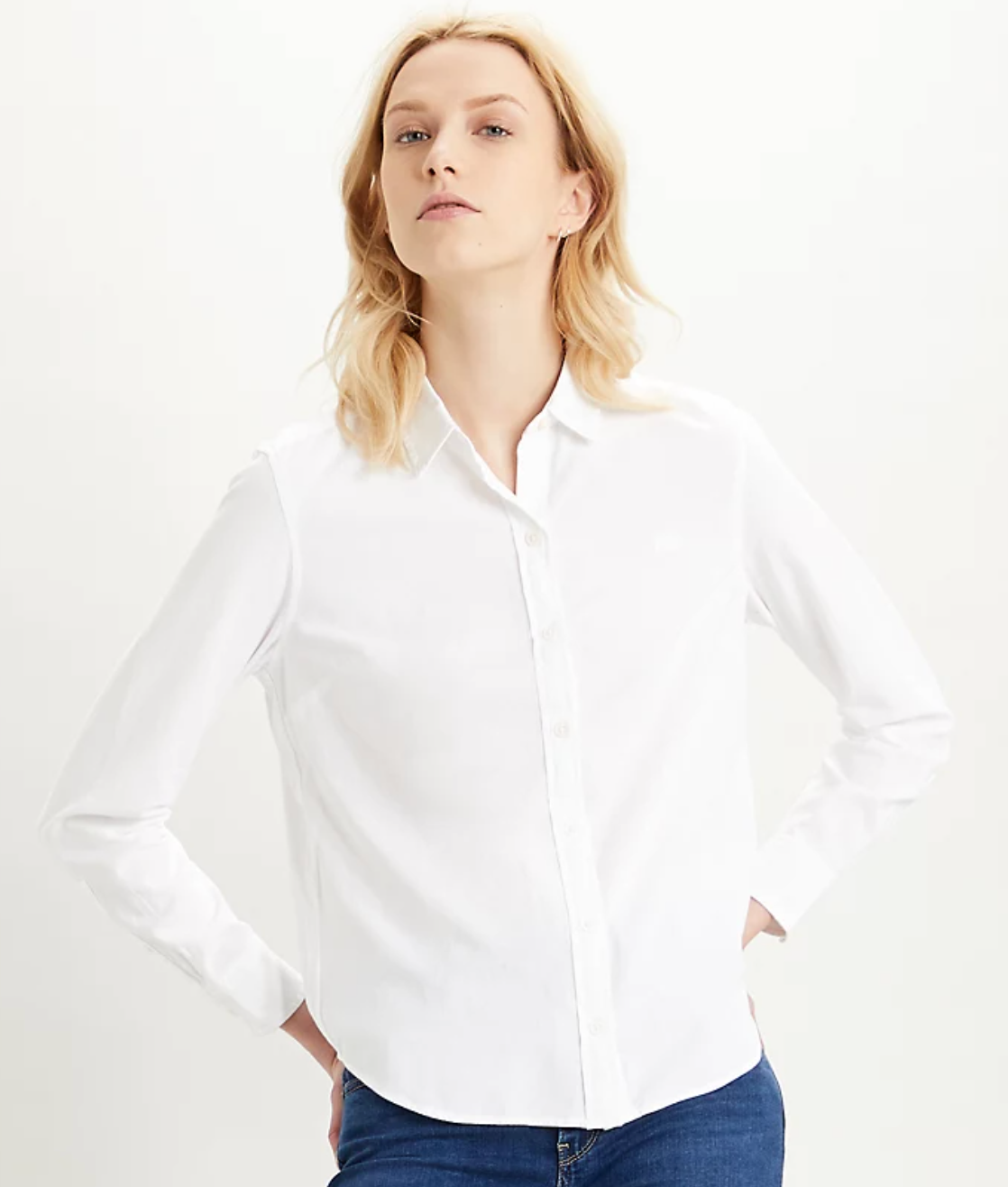 a person wearing a long sleeved white button up shirt