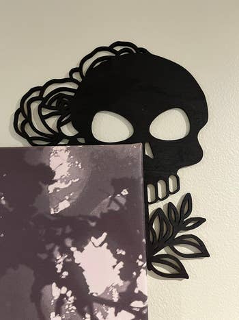 a skull corner sign hugging the side of a painting