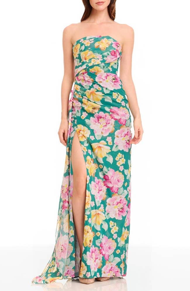 Person modeling a strapless floral-print dress with a thigh-high slit, suitable for shopping or a casual event