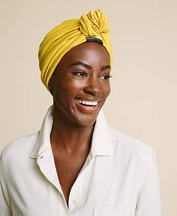 a model wearing the turban in yellow 