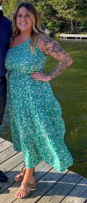 reviewer wearing the dress in a green and white patterned dress