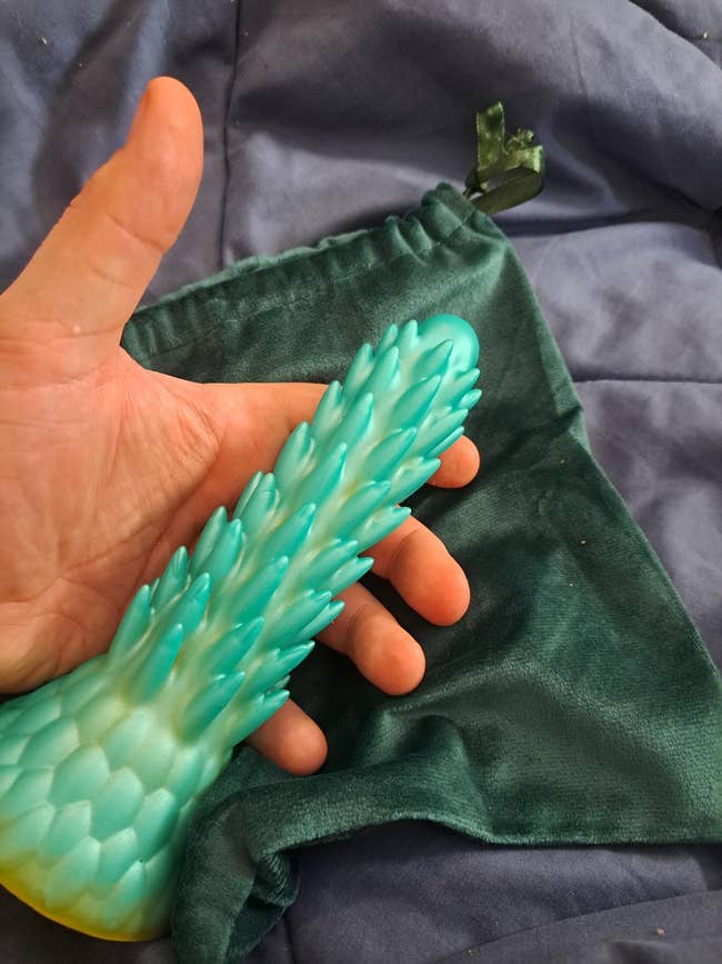 Person holding a textured entity with a velvet pouch nearby, perchance related to buying oregon merchandise review