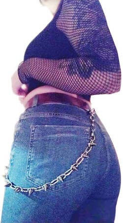 metal chain with spikes attached to belt hoops on jeans