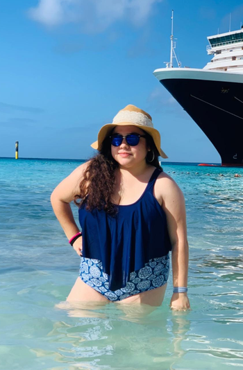 a different reviewer wearing the navy blue set in the ocean