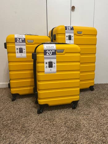 reviewer's three yellow suitcases next to each other, sizes 20