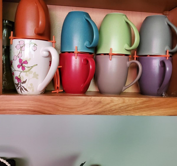 reviewer's mugs stacked on top of each other using the orange organizer